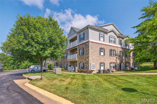5 Monarch Trace Ct Unit 305, Chesterfield, MO 63017 - view of side of property featuring stone siding and a lawn