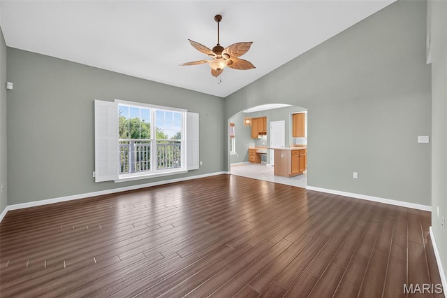 5 Monarch Trace Ct Unit 305, Chesterfield, MO 63017 - unfurnished living room featuring arched walkways, wood finished floors, and a ceiling fan