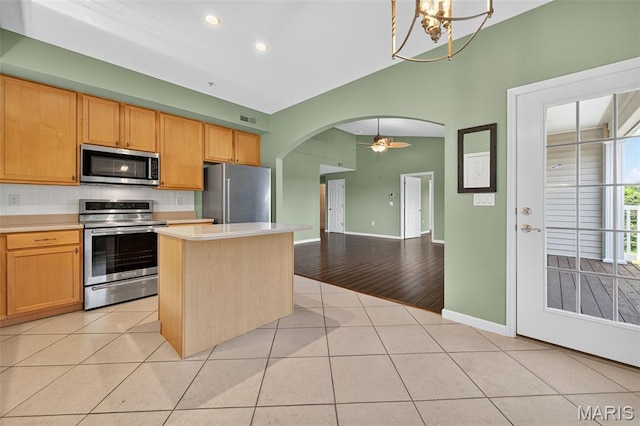 5 Monarch Trace Ct Unit 305, Chesterfield, MO 63017 - kitchen with appliances with stainless steel finishes, light countertops, arched walkways, tasteful backsplash, and light tile patterned floors