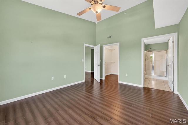 5 Monarch Trace Ct Unit 305, Chesterfield, MO 63017 - unfurnished bedroom featuring a walk in closet, wood finished floors, a closet, a high ceiling, and ceiling fan