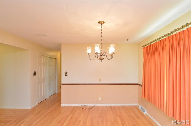 318 W Oak St, Mascoutah, IL 62258 - spare room with light wood-style flooring and a chandelier