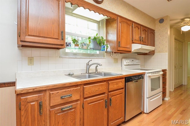 318 W Oak St, Mascoutah, IL 62258 - kitchen featuring dishwasher, electric stove, under cabinet range hood, brown cabinets, and wallpapered walls