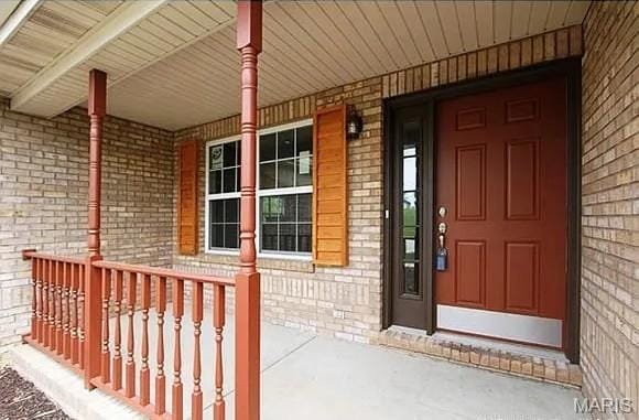 2763 Cascade Lake Dr, Belleville, IL 62221 - doorway to property with covered porch and brick siding