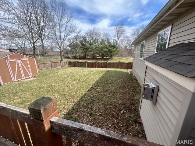 2763 Cascade Lake Dr, Belleville, IL 62221 - fenced backyard featuring a shed