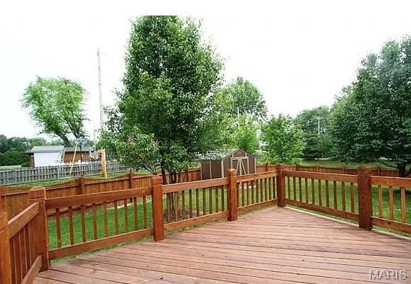 2763 Cascade Lake Dr, Belleville, IL 62221 - wooden terrace featuring a shed and a fenced backyard