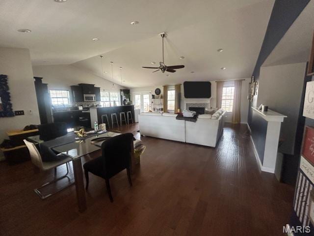 2763 Cascade Lake Dr, Belleville, IL 62221 - dining room featuring lofted ceiling, a fireplace, a ceiling fan, plenty of natural light, and dark wood-style floors