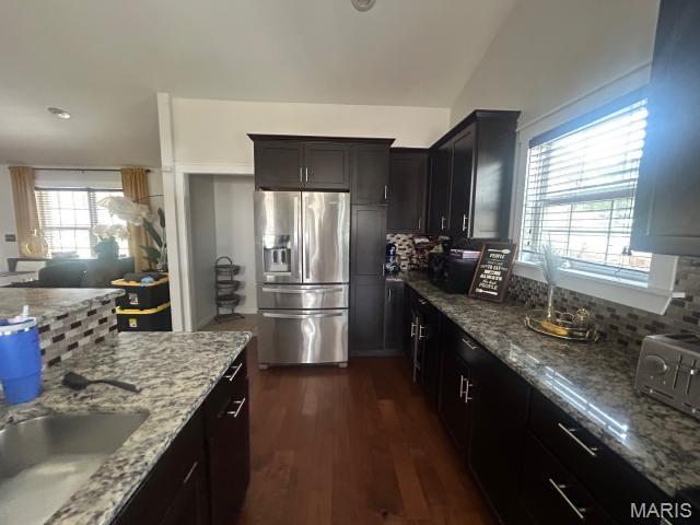 2763 Cascade Lake Dr, Belleville, IL 62221 - kitchen with stainless steel fridge with ice dispenser, decorative backsplash, light stone countertops, dark wood-type flooring, and vaulted ceiling