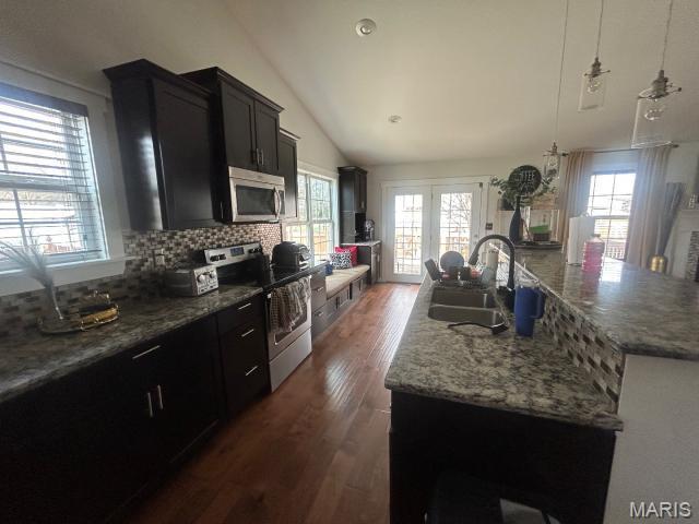 2763 Cascade Lake Dr, Belleville, IL 62221 - kitchen with appliances with stainless steel finishes, a center island with sink, lofted ceiling, dark wood finished floors, and dark cabinetry