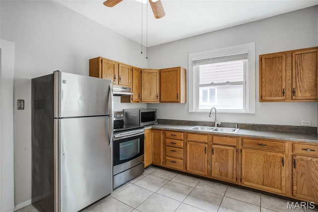 2617 Sutton Blvd, Maplewood, MO 63143 - kitchen featuring appliances with stainless steel finishes, range hood, brown cabinets, light tile patterned flooring, and dark countertops