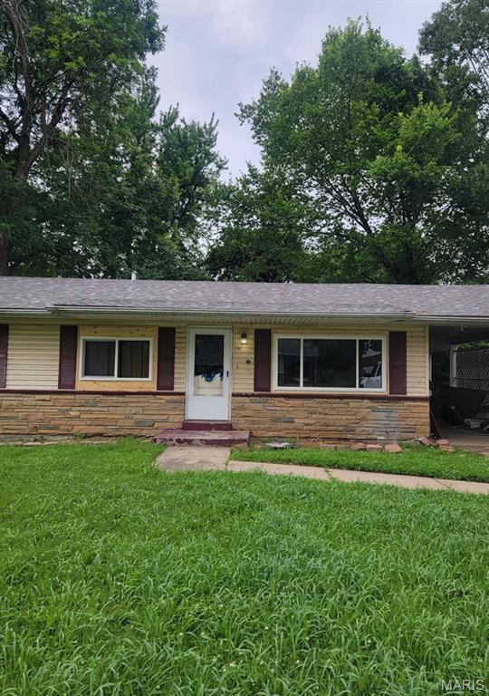 9909 Glen Owen Dr, Saint Louis, MO 63136 - ranch-style house featuring stone siding, a front lawn, and a carport