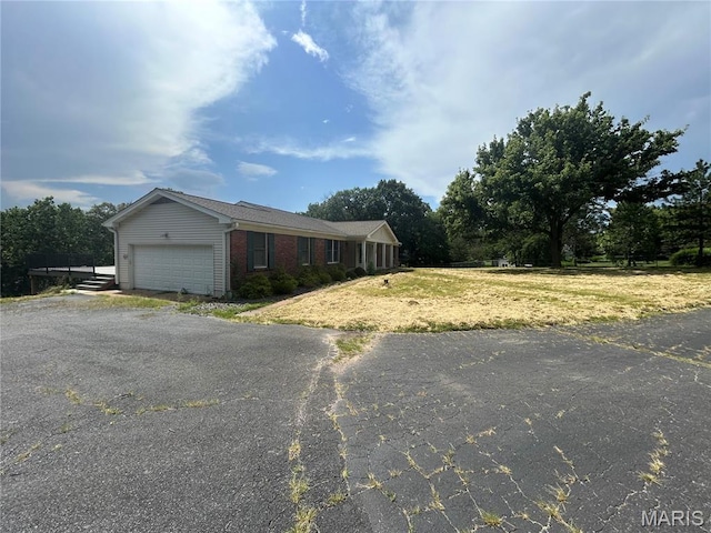 17300 W Bridle Trl, Wildwood, MO 63038 - view of front of home with an attached garage, driveway, and brick siding