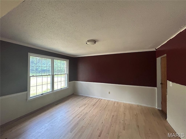 17300 W Bridle Trl, Wildwood, MO 63038 - unfurnished room featuring a textured ceiling, wood finished floors, and ornamental molding