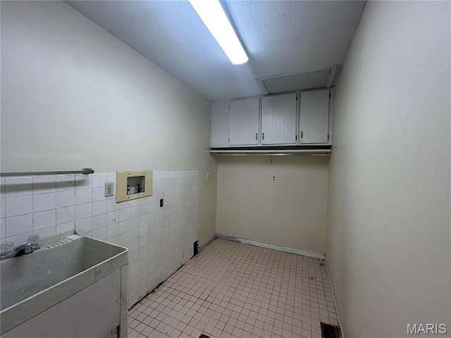 17300 W Bridle Trl, Wildwood, MO 63038 - laundry room with cabinet space, washer hookup, tile walls, and light tile patterned flooring