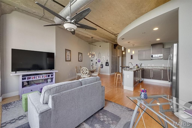 4100 Forest Park Ave Unit 306, Saint Louis, MO 63108 - living area featuring light wood-style floors, a ceiling fan, recessed lighting, and a chandelier