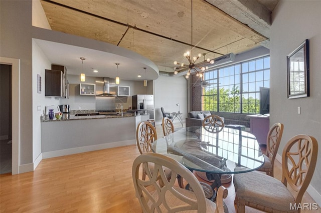 4100 Forest Park Ave Unit 306, Saint Louis, MO 63108 - dining space with light wood-style flooring and a chandelier