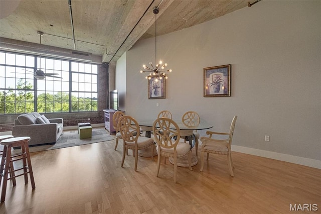 4100 Forest Park Ave Unit 306, Saint Louis, MO 63108 - dining space with wood finished floors and a chandelier