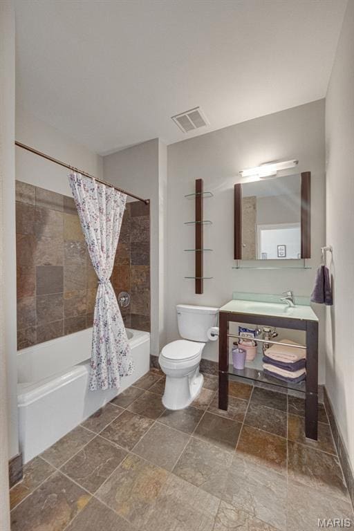 4100 Forest Park Ave Unit 306, Saint Louis, MO 63108 - bathroom featuring shower / tub combo with curtain, stone tile flooring, and vanity