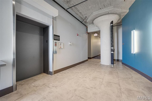 4100 Forest Park Ave Unit 306, Saint Louis, MO 63108 - hallway with concrete flooring and elevator