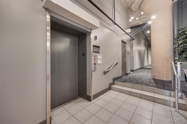 4100 Forest Park Ave Unit 306, Saint Louis, MO 63108 - corridor featuring elevator and light tile patterned floors