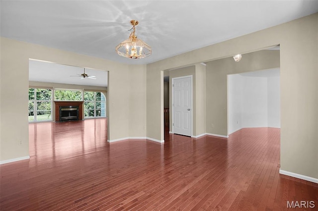 1473 Crooked Stick Dr, Ofallon, MO 63366 - spare room with a chandelier, ceiling fan, wood finished floors, and a fireplace
