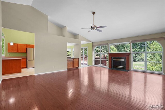 1473 Crooked Stick Dr, Ofallon, MO 63366 - unfurnished living room with wood-type flooring, ceiling fan, high vaulted ceiling, and a high end fireplace