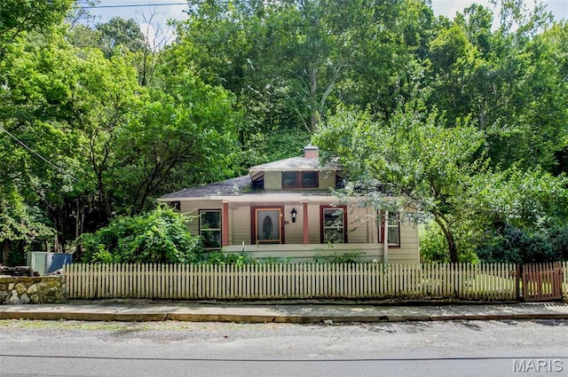 86 Mill St, Elsah, IL 62028 - view of front of home with a porch, a chimney, and a fenced front yard