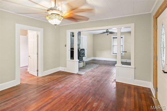 86 Mill St, Elsah, IL 62028 - foyer with a ceiling fan, ornate columns, wood-type flooring, a wood stove, and ornamental molding