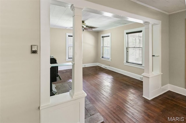 86 Mill St, Elsah, IL 62028 - empty room featuring ornate columns, crown molding, dark wood-style flooring, and a ceiling fan
