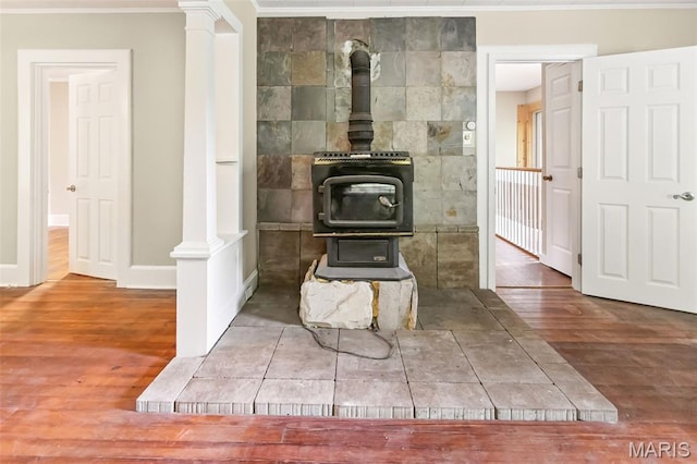 86 Mill St, Elsah, IL 62028 - detailed view of a wood stove, wood finished floors, and crown molding