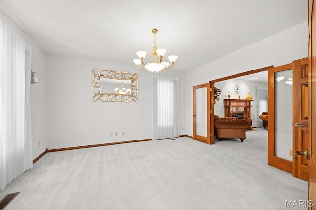 517 E Waters Edge Dr, Shiloh, IL 62221 - unfurnished room featuring a chandelier, light colored carpet, and french doors