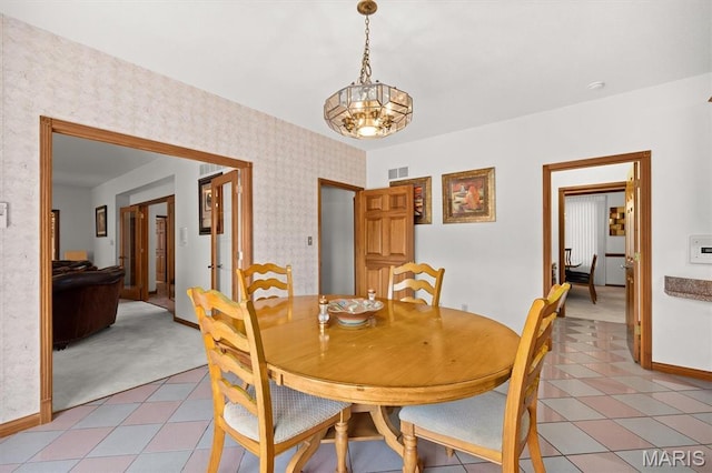 517 E Waters Edge Dr, Shiloh, IL 62221 - dining area featuring a chandelier, light colored carpet, and wallpapered walls