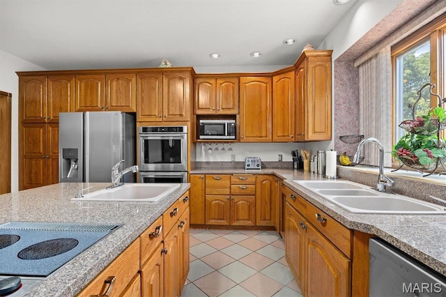 517 E Waters Edge Dr, Shiloh, IL 62221 - kitchen featuring stainless steel appliances, brown cabinets, light countertops, light tile patterned flooring, and recessed lighting