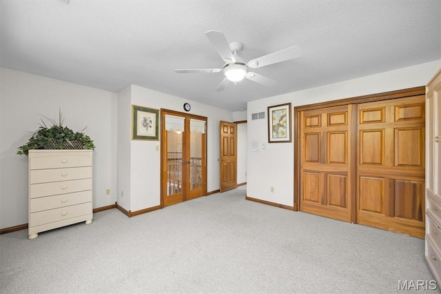 517 E Waters Edge Dr, Shiloh, IL 62221 - unfurnished bedroom with french doors, light colored carpet, a ceiling fan, and a textured ceiling