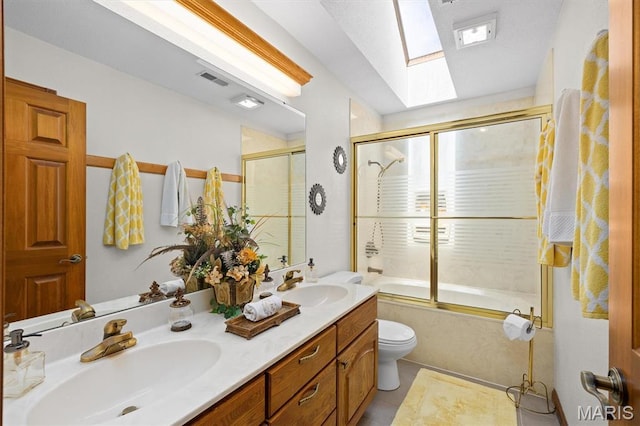 517 E Waters Edge Dr, Shiloh, IL 62221 - bathroom featuring a skylight, double vanity, shower / bath combination with glass door, and tile patterned flooring