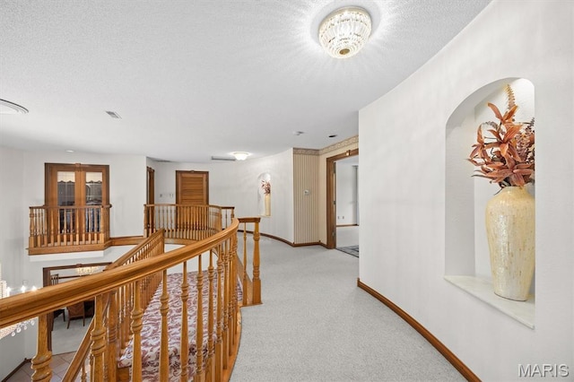 517 E Waters Edge Dr, Shiloh, IL 62221 - corridor with an upstairs landing, arched walkways, carpet floors, a textured ceiling, and a chandelier