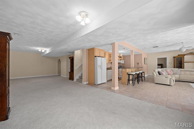 517 E Waters Edge Dr, Shiloh, IL 62221 - living room featuring light colored carpet, stairway, and light tile patterned flooring
