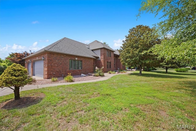 517 E Waters Edge Dr, Shiloh, IL 62221 - view of home's exterior featuring brick siding, a garage, a yard, and a shingled roof