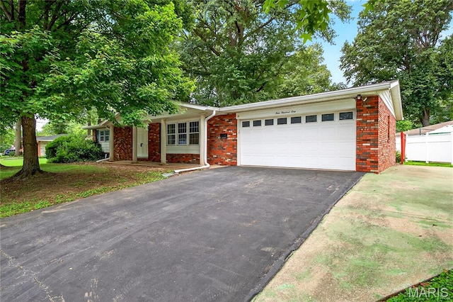 401 Willowbrook Ln, Collinsville, IL 62234 - ranch-style house featuring brick siding, an attached garage, and asphalt driveway
