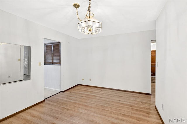 401 Willowbrook Ln, Collinsville, IL 62234 - spare room featuring light wood-type flooring and a chandelier