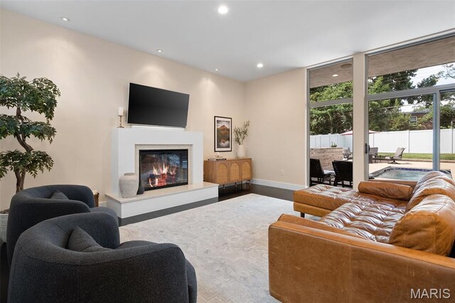 5951 Jamieson Ave, Saint Louis, MO 63109 - living area featuring a glass covered fireplace, recessed lighting, and a wall of windows