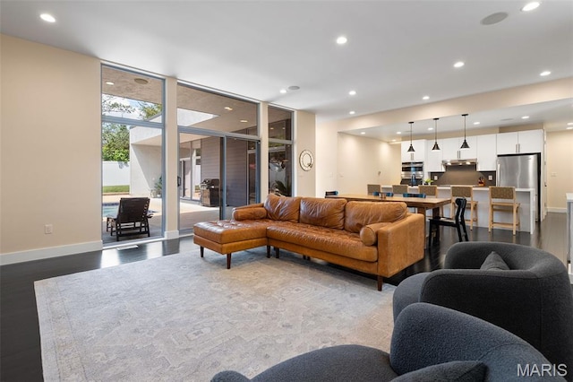 5951 Jamieson Ave, Saint Louis, MO 63109 - living room with dark wood-style floors, recessed lighting, and expansive windows
