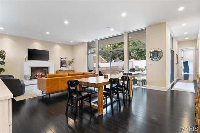 5951 Jamieson Ave, Saint Louis, MO 63109 - dining space with dark wood-style flooring, a glass covered fireplace, and recessed lighting