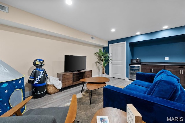5951 Jamieson Ave, Saint Louis, MO 63109 - living area featuring beverage cooler, light wood-type flooring, recessed lighting, and bar