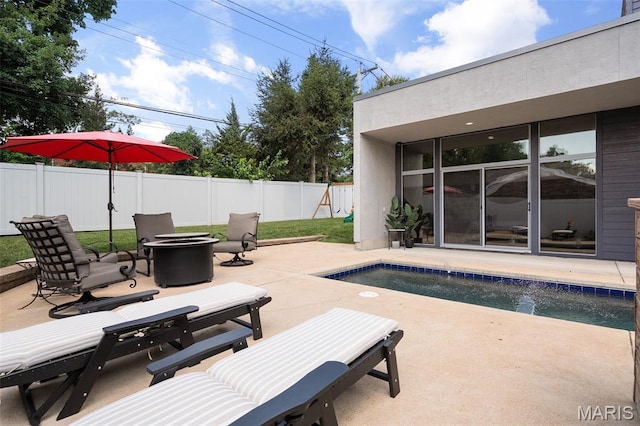 5951 Jamieson Ave, Saint Louis, MO 63109 - view of swimming pool with a patio, a fenced backyard, and an outdoor fire pit