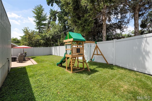 5951 Jamieson Ave, Saint Louis, MO 63109 - fenced backyard featuring a playground and a patio area