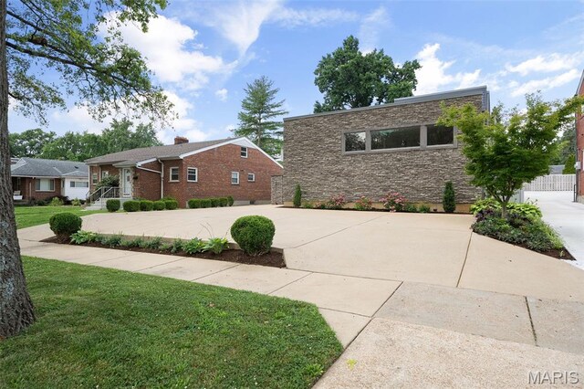 5951 Jamieson Ave, Saint Louis, MO 63109 - view of front of property with stone siding and concrete driveway