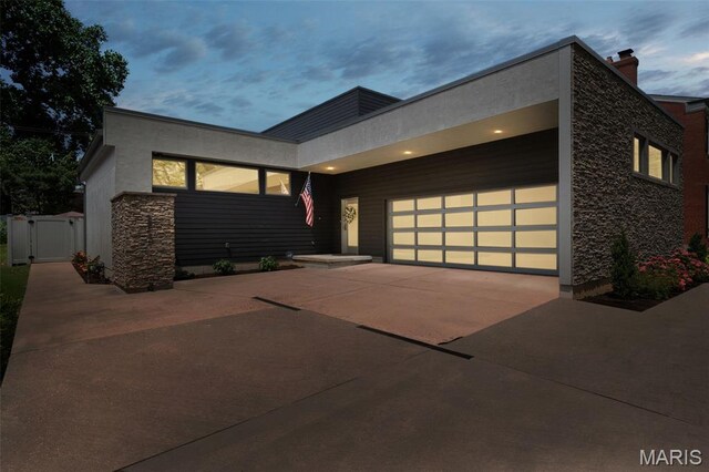 5951 Jamieson Ave, Saint Louis, MO 63109 - contemporary home with concrete driveway, a garage, and a gate