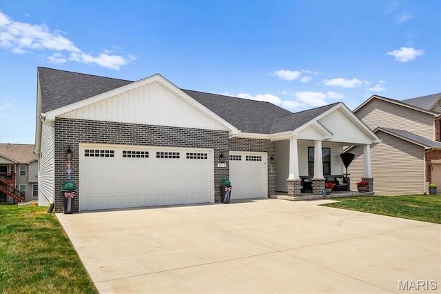 1433 Victoria Square Ct, Ofallon, IL 62269 - view of front of home featuring a garage, board and batten siding, brick siding, concrete driveway, and roof with shingles