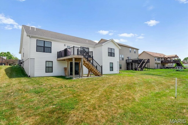 1433 Victoria Square Ct, Ofallon, IL 62269 - back of property with stairway, a wooden deck, and a lawn