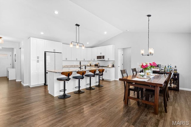 1433 Victoria Square Ct, Ofallon, IL 62269 - dining space with vaulted ceiling, dark wood finished floors, a chandelier, and recessed lighting